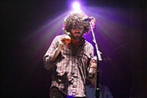 Daniel Bejar of Destroyer performing with beer and maraca