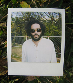 Daniel Bejar Destroyer wearing sunglasses and white shirt in polaroid picture